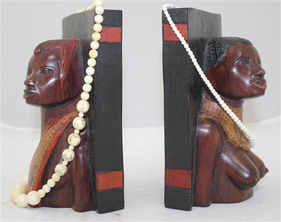 Ivory elephant on stand, a pair of bookends and two ivory bead necklaces